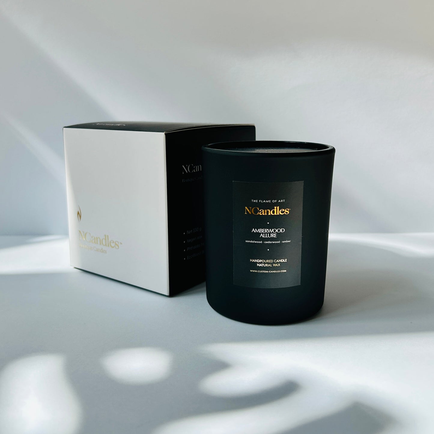 black candle with box and white background