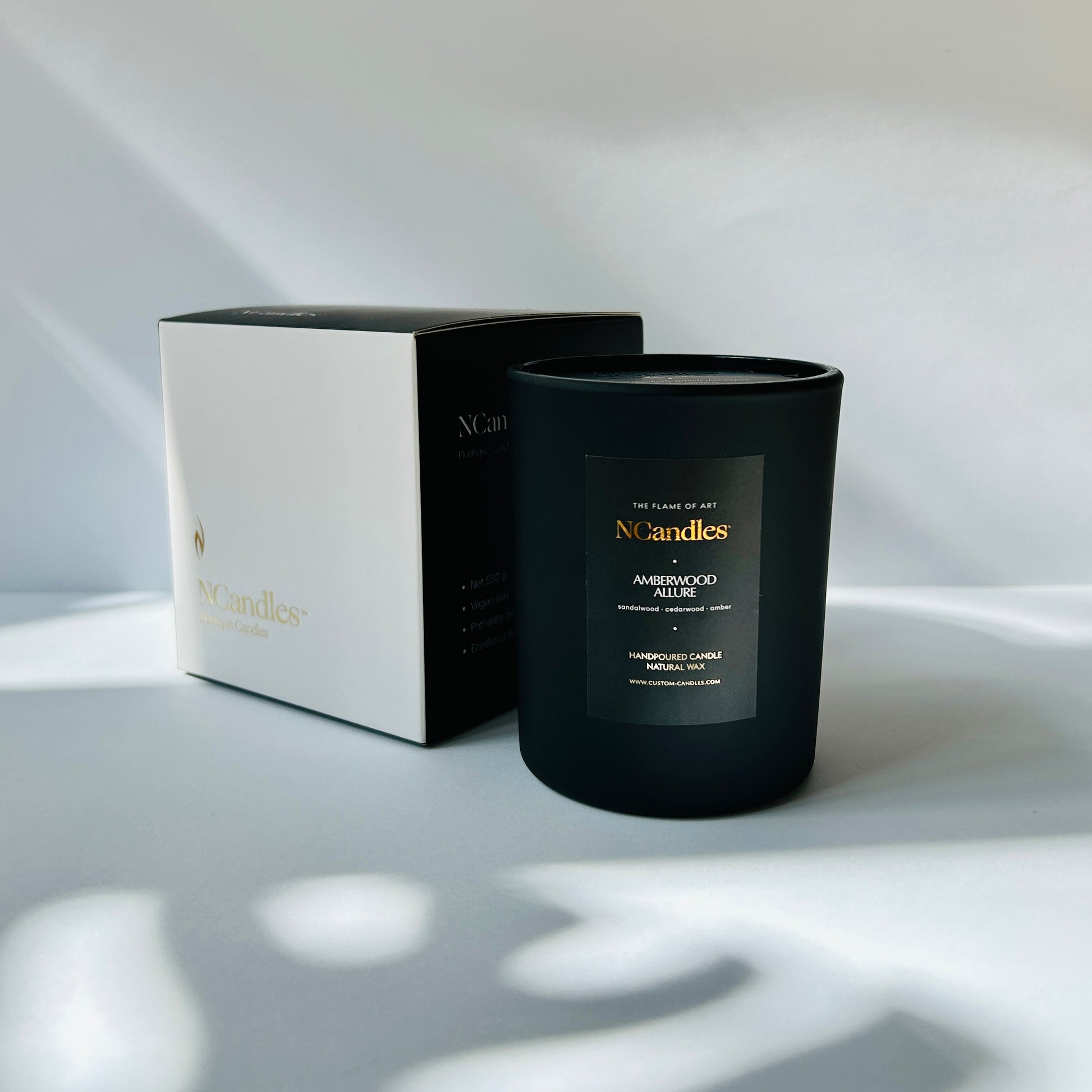 black candle with box and white background