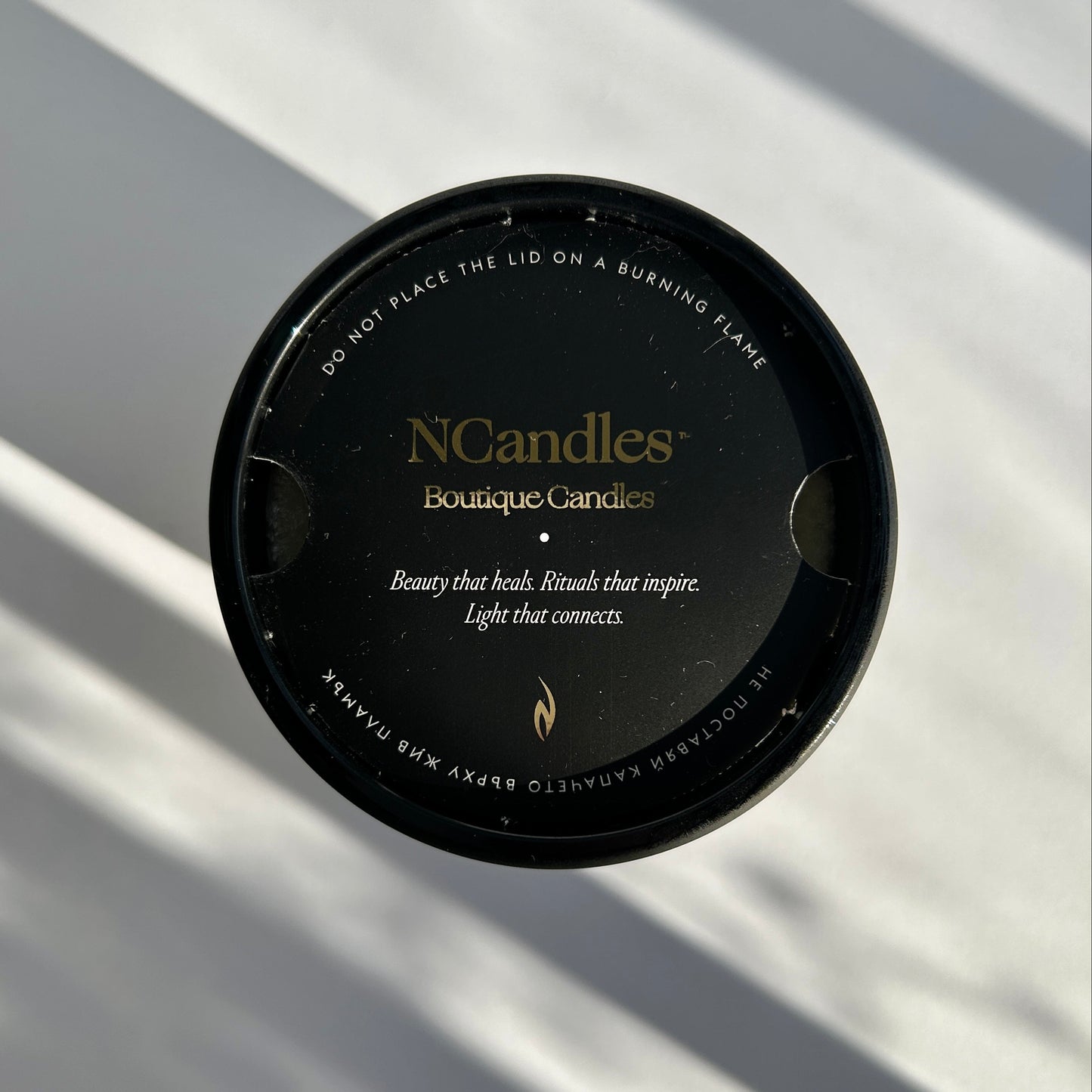 black candle with amber wood scent