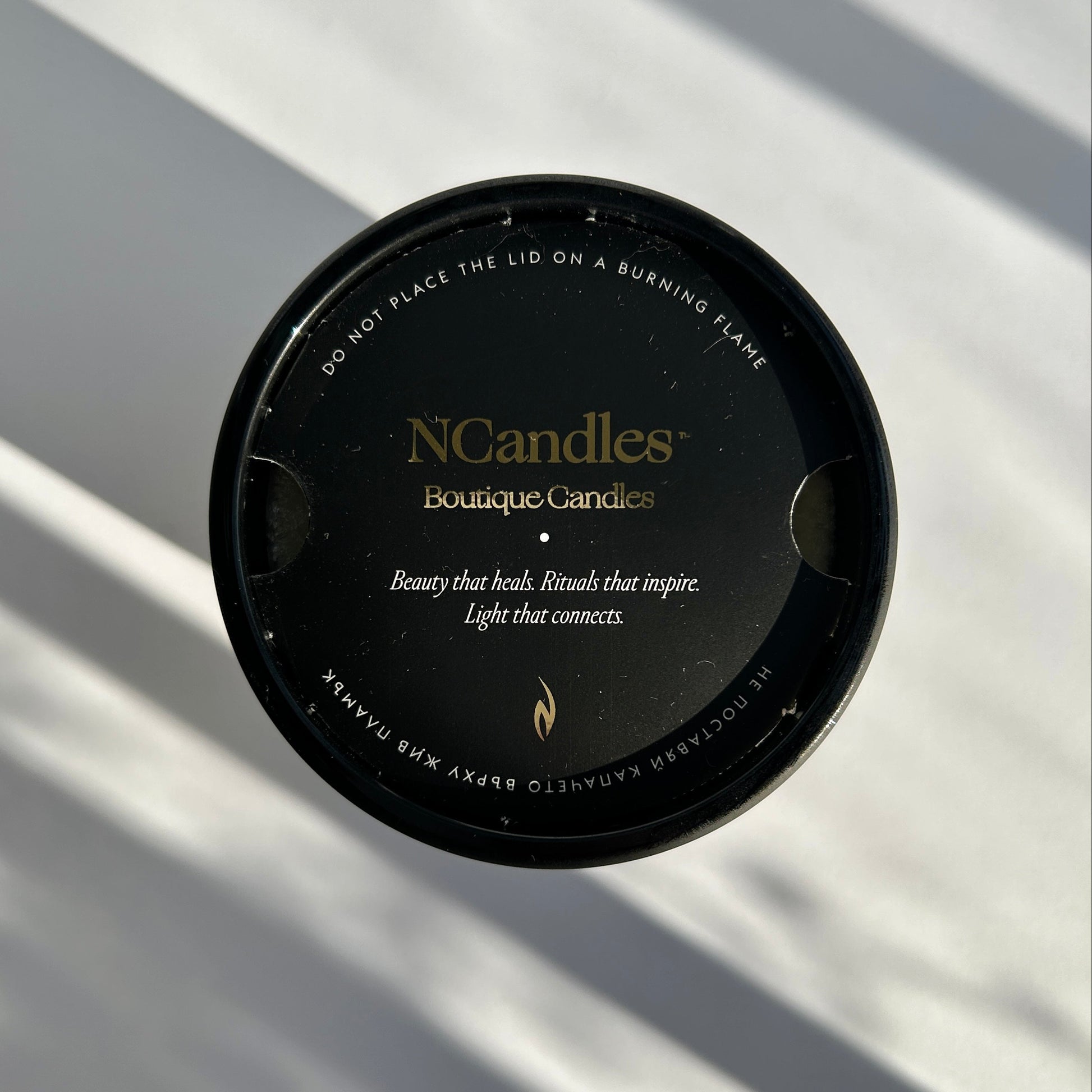black candle with amber wood scent